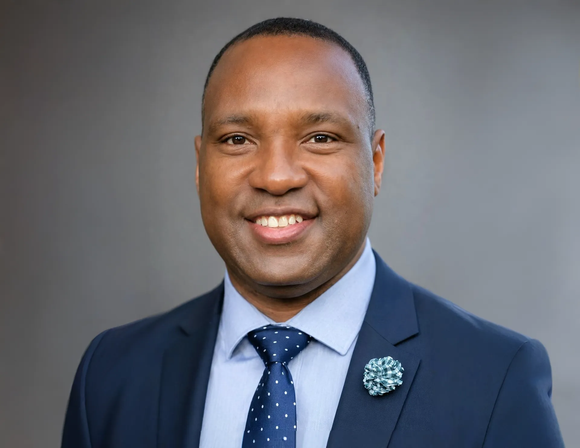 Professional headshot of a smiling real estate professional