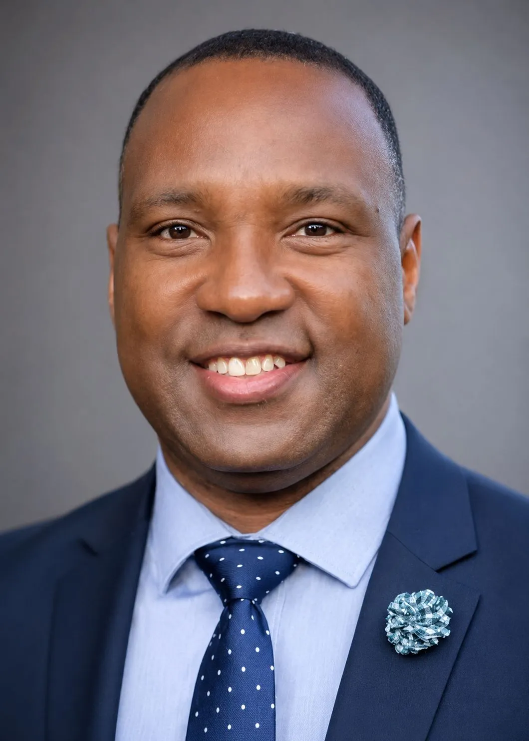 Professional headshot of a smiling real estate professional