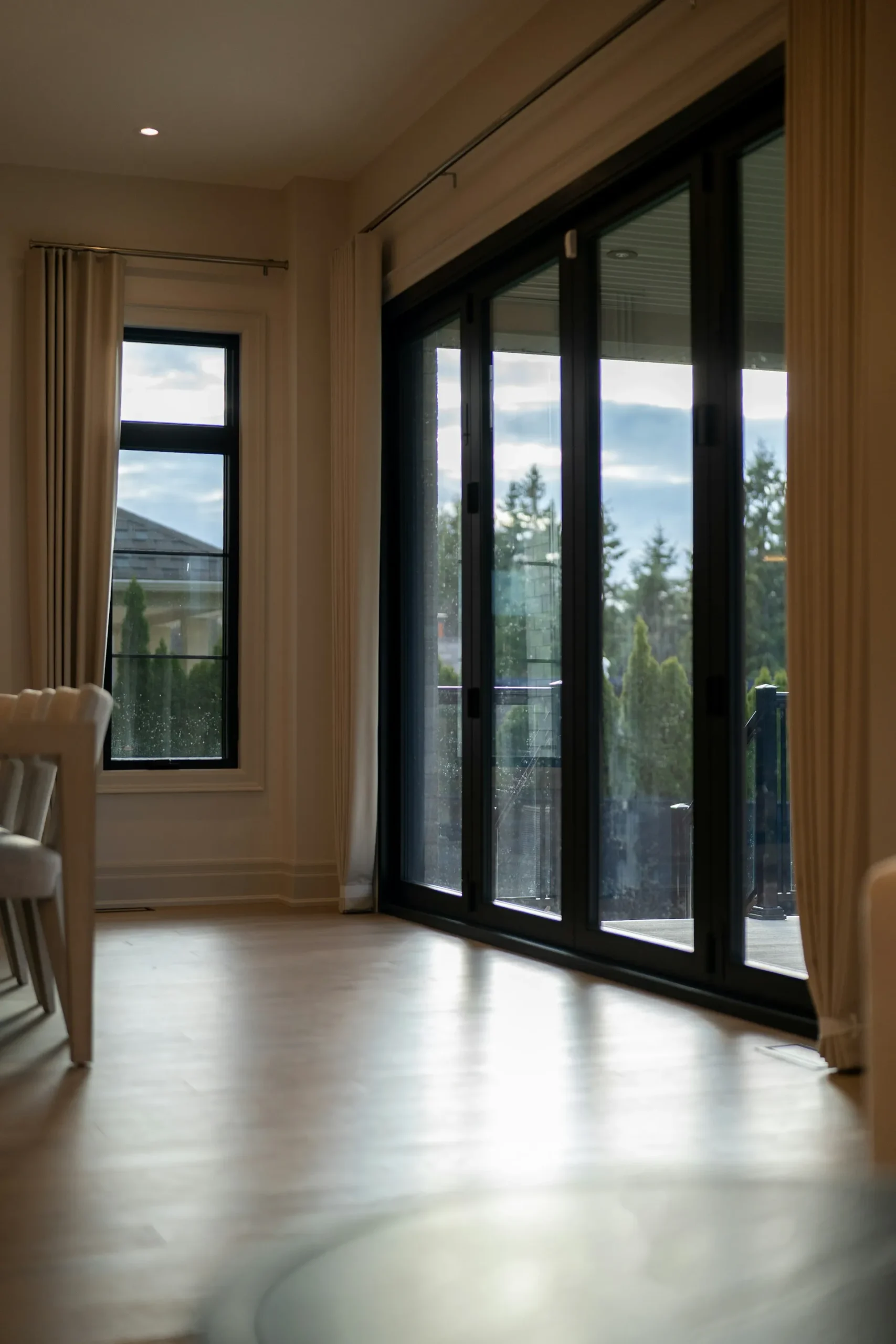 Modern interior with large windows overlooking greenery